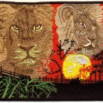 Lions and sunset in Africa on the embroidered patch